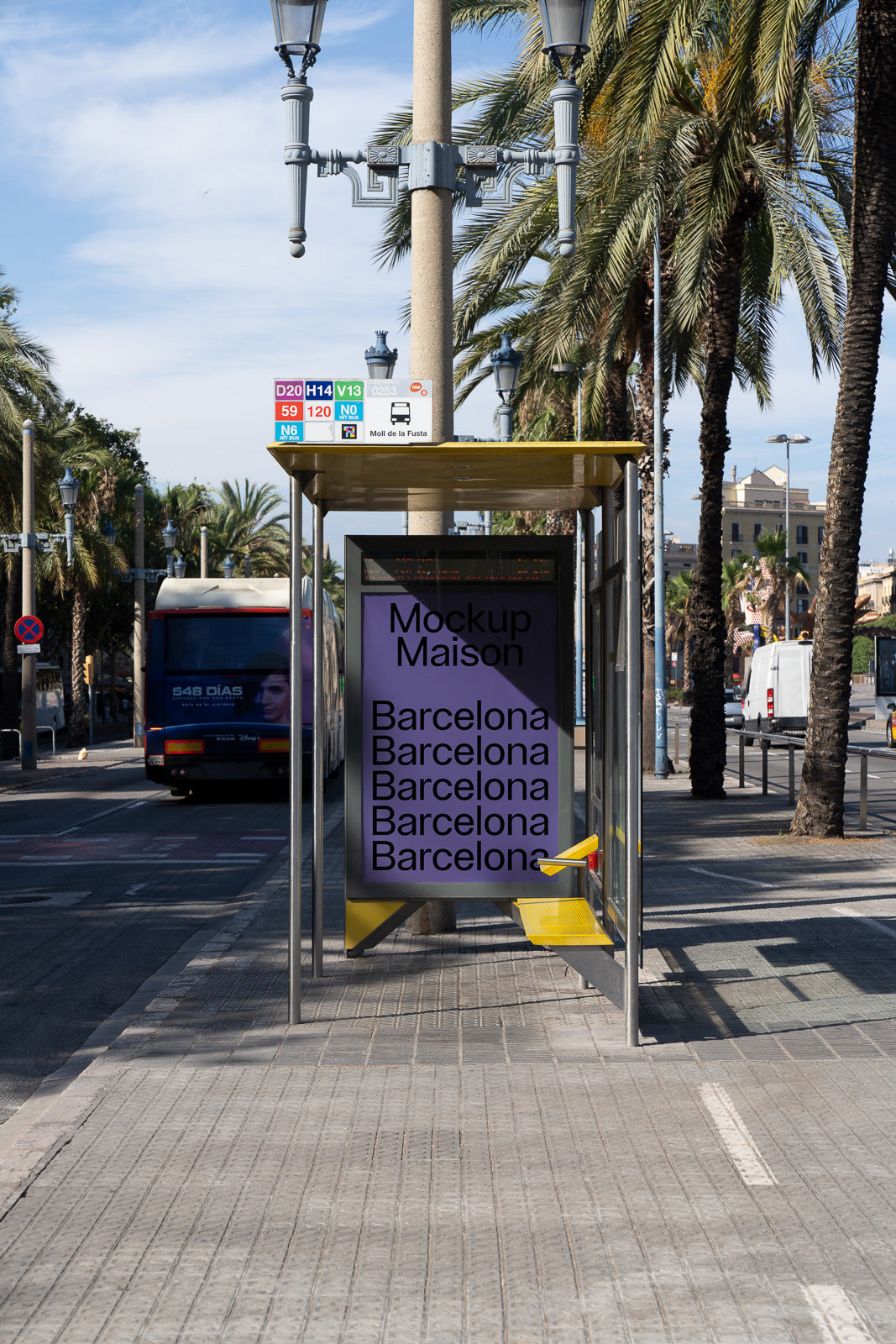 PSD mockup of a city bus stop with a purple poster displaying text "Mockup Maison" and "Barcelona" repeatedly under palm trees and clear sky.