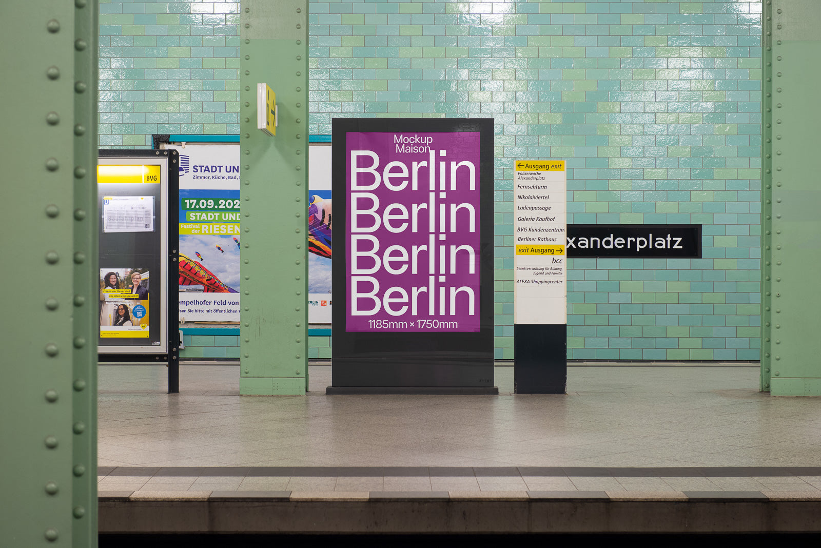 PSD mockup of a subway station with a poster reading "Berlin" multiple times in white text on a purple background, Alexanderplatz signage visible.
