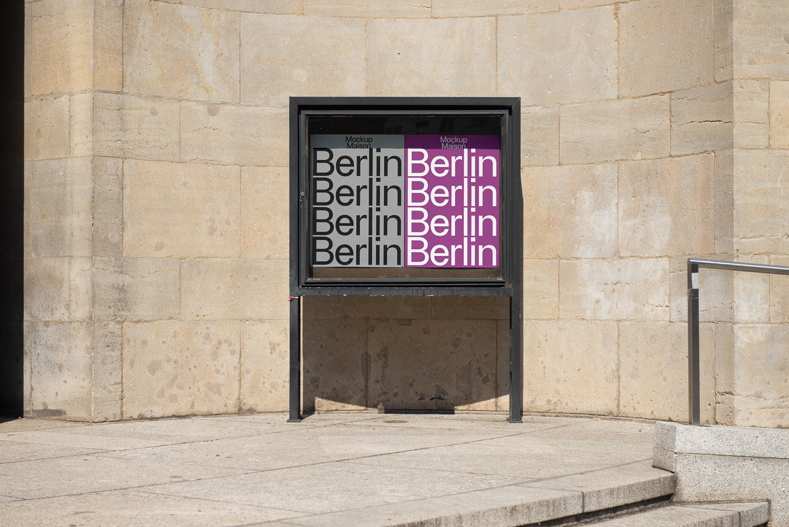 PSD mockup of a Berlin poster displayed in an outdoor advertising stand, featuring alternating black and magenta text against a stone wall backdrop.