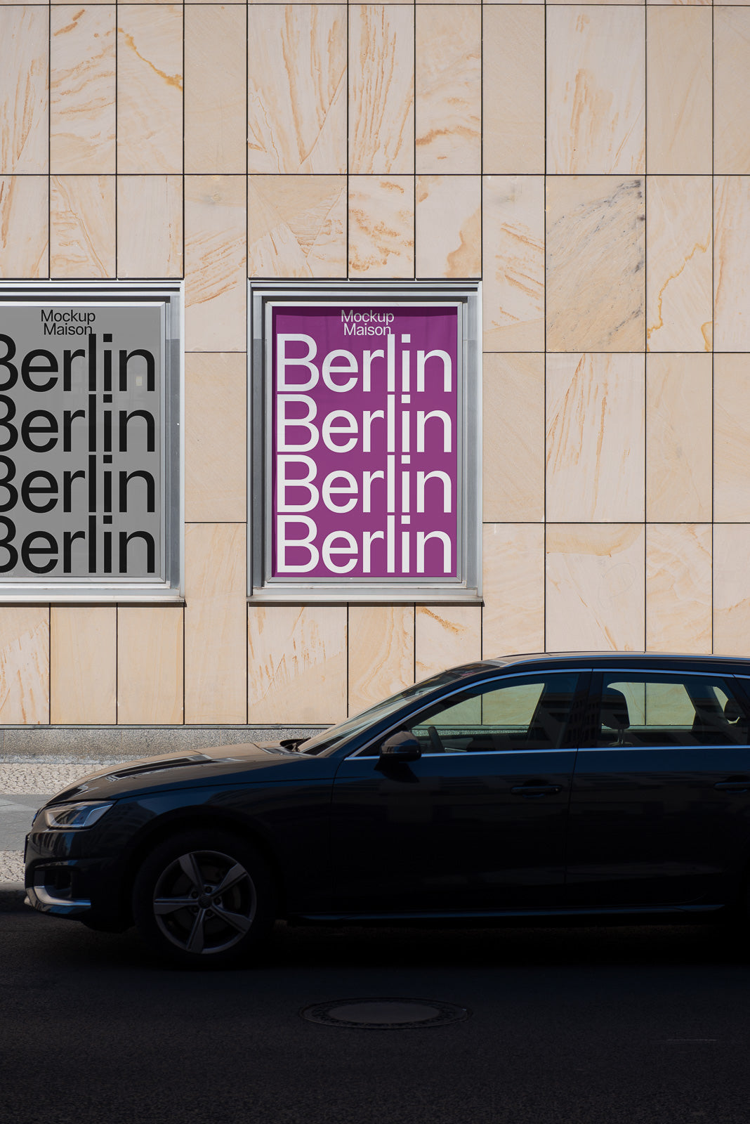 PSD mockup of two posters labeled "Berlin" in a grid design, displayed on a building wall; one with a gray background and one with a purple background, car parked below.