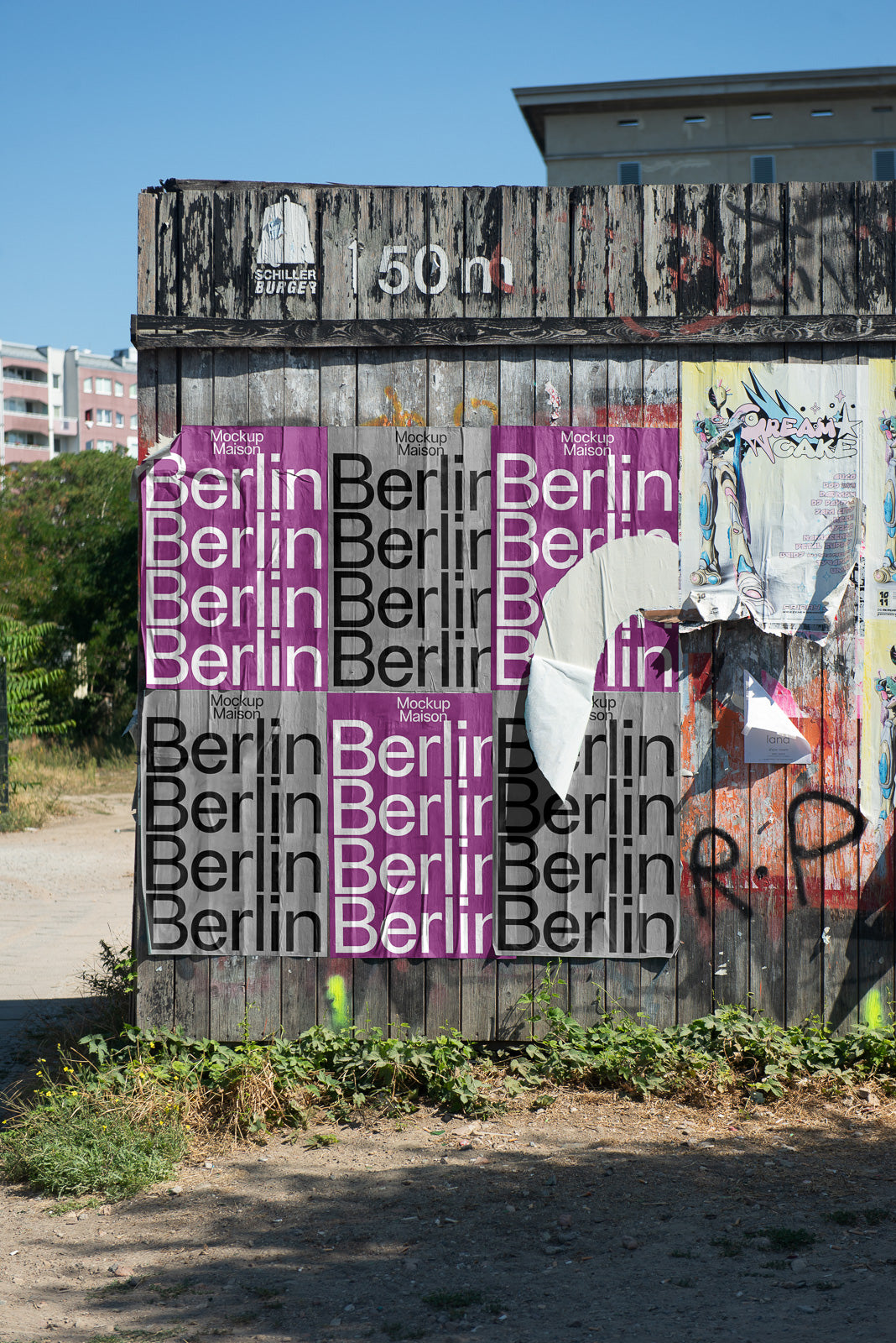 PSD mockup of weathered wooden wall with layered Berlin posters in purple and black, surrounded by urban elements and graffiti.