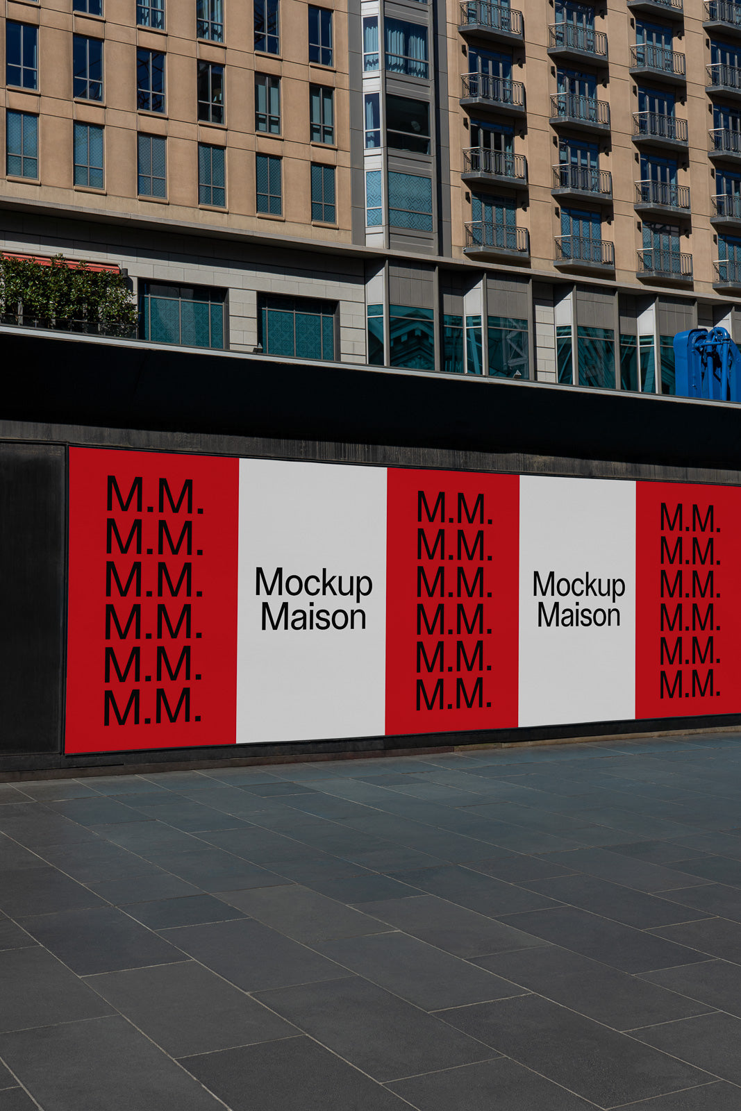 PSD mockup of a modern city billboard displaying repetitive “M.M.” pattern and “Mockup Maison” text against a backdrop of urban architecture.