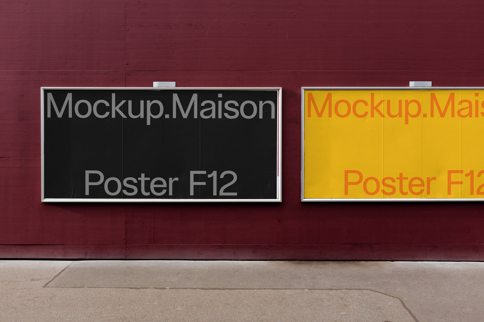 PSD mockup of two framed posters on a maroon wall; one is black with light gray text, the other yellow with orange text.