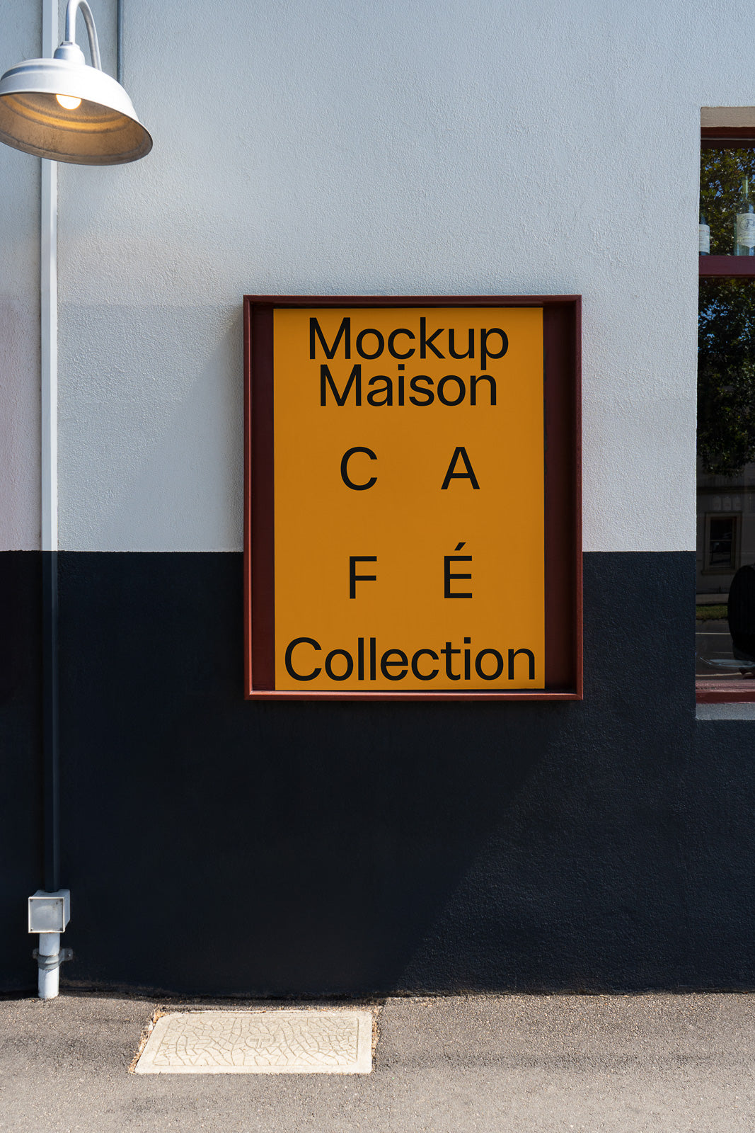 PSD mockup of a framed poster on an exterior wall displaying the text "Mockup Maison Café Collection" in bold letters.