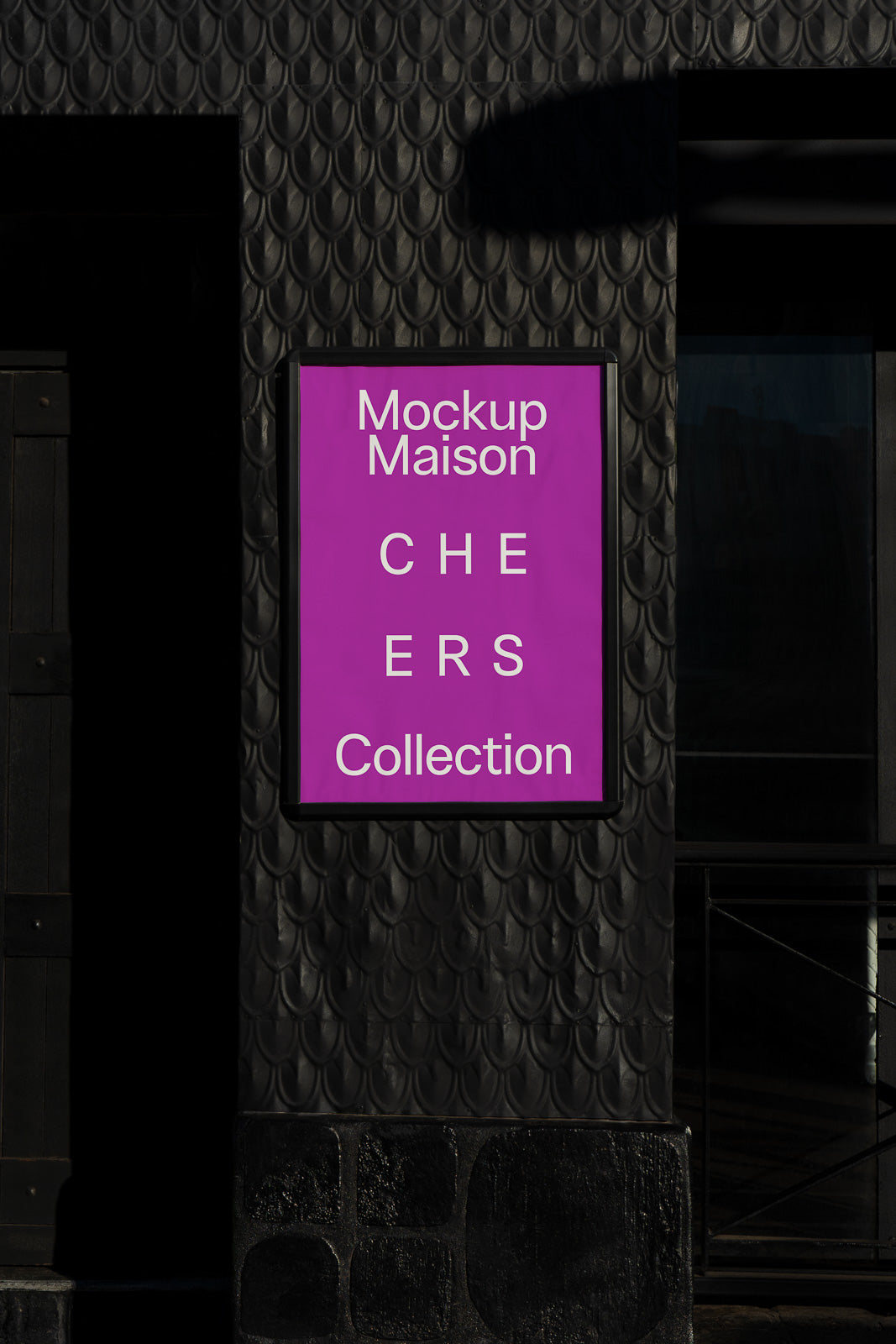 PSD mockup of a wall-mounted poster displaying the text "Mockup Maison CHE ERS Collection" on a purple background, set against a textured dark wall.