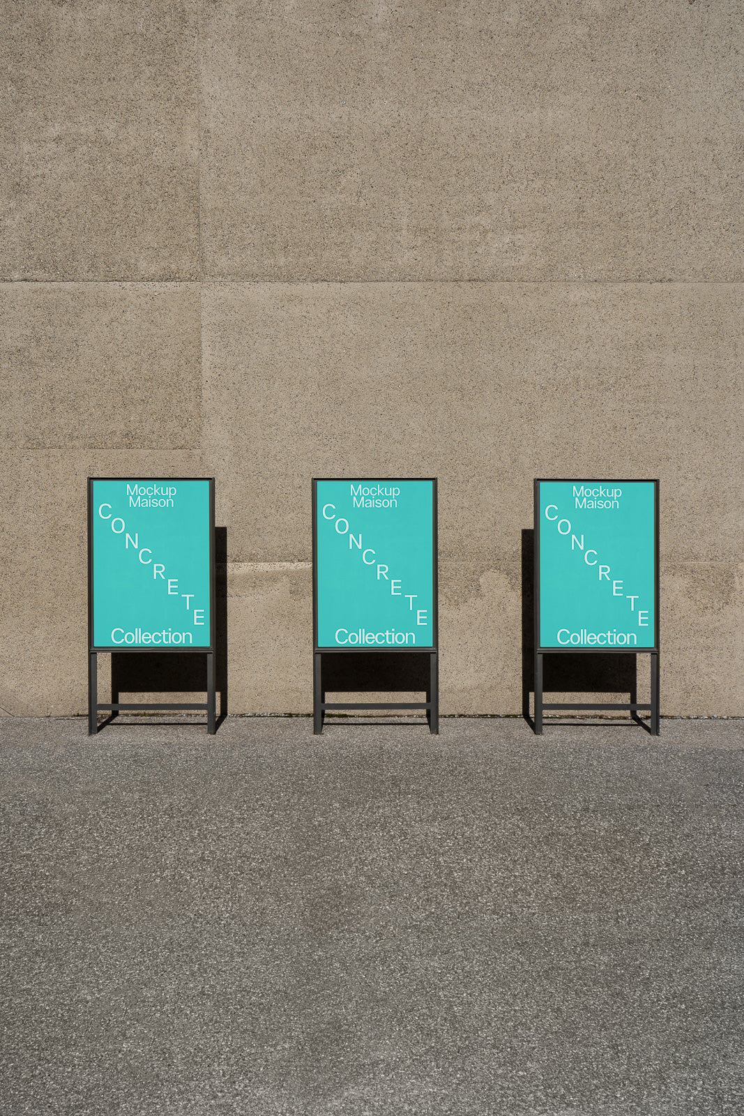 PSD mockup of three black metal frames with turquoise posters titled "Concrete Collection" against a textured concrete wall.