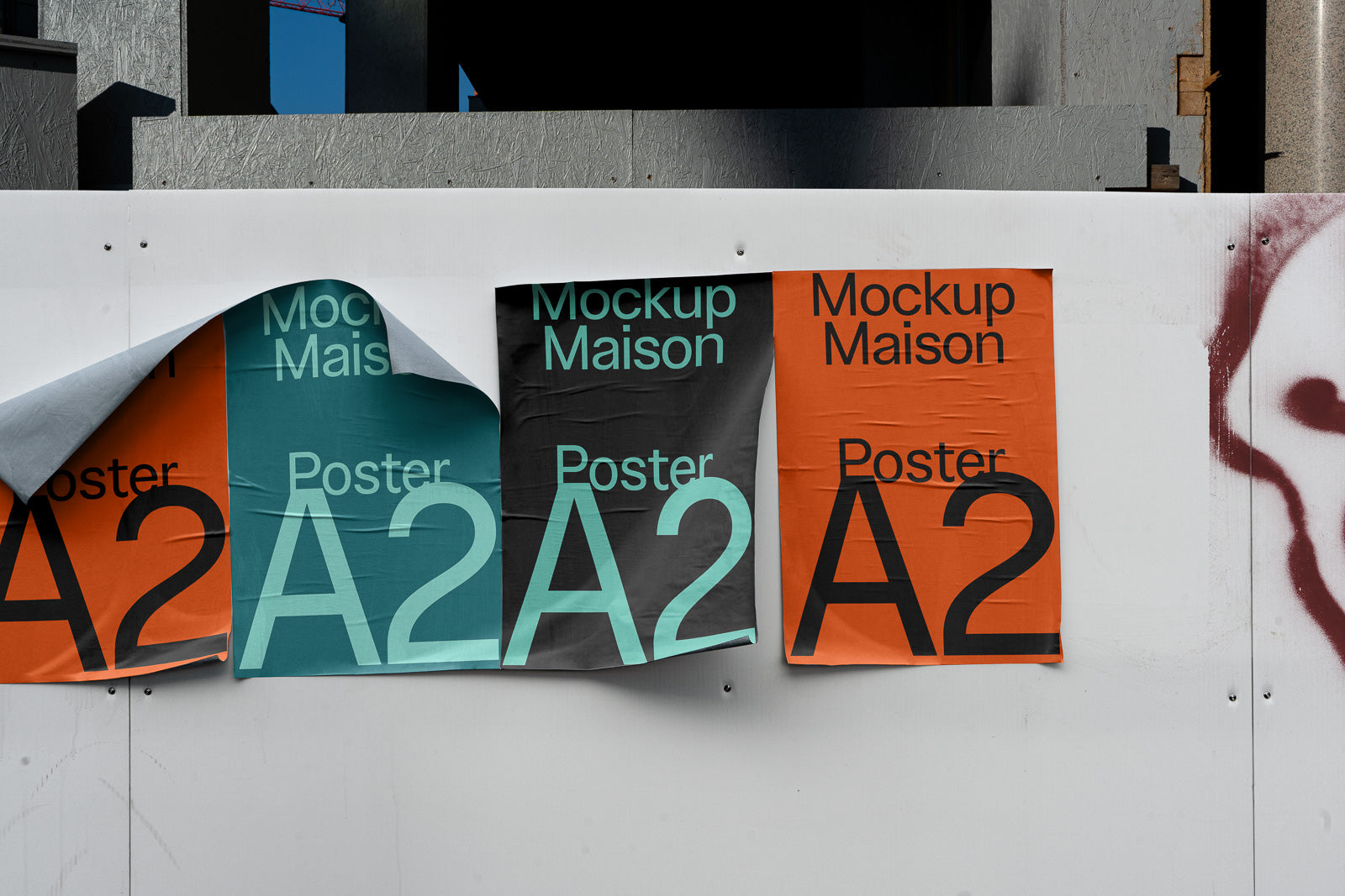 PSD mockup of three A2 posters on a wall, showcasing vibrant orange, teal, and black designs. The left poster is partially peeled back, revealing another layer.