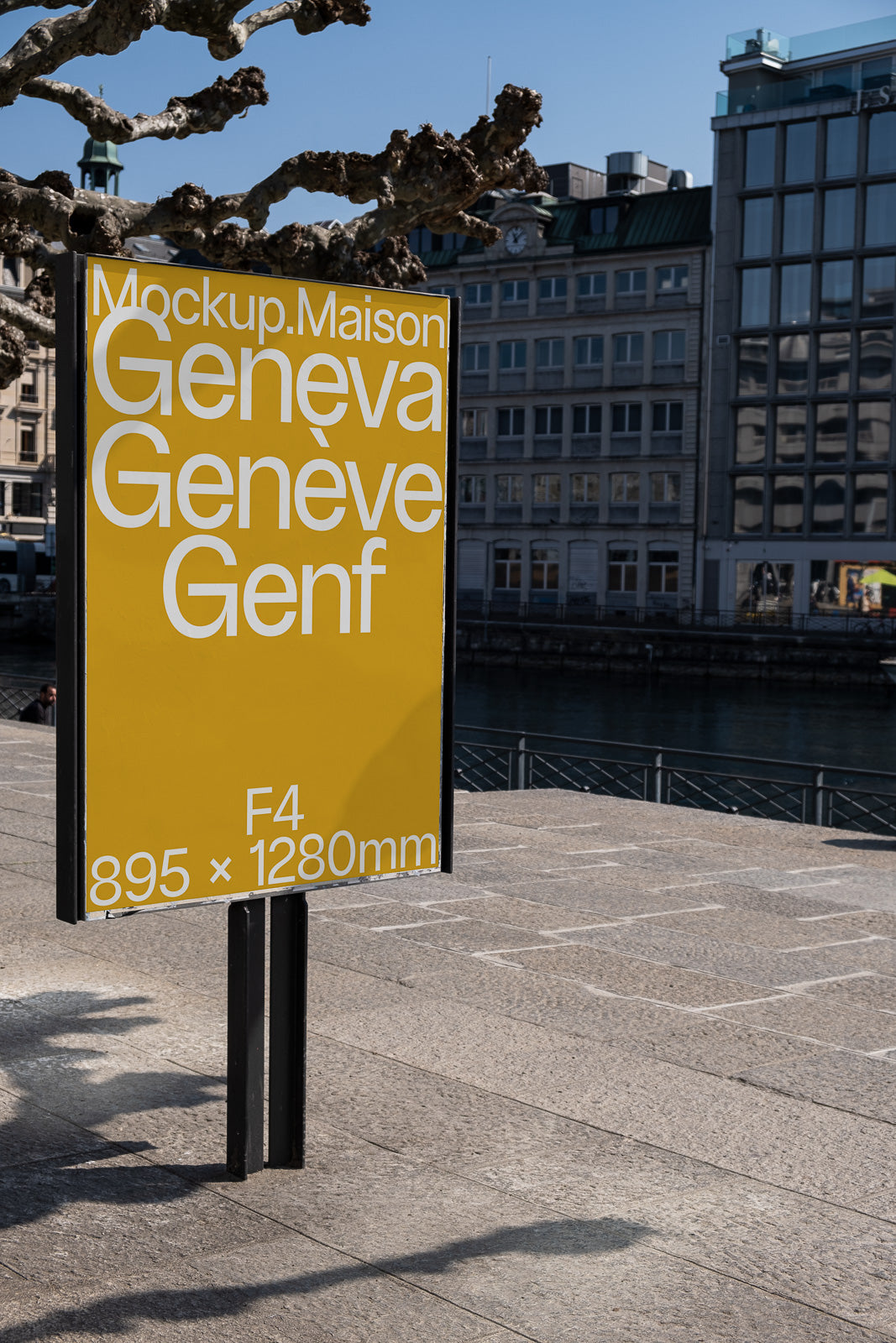 PSD mockup of a yellow sign displaying "Geneva, Genève, Genf" and dimensions "F4 895 x 1280mm," with a cityscape backdrop.