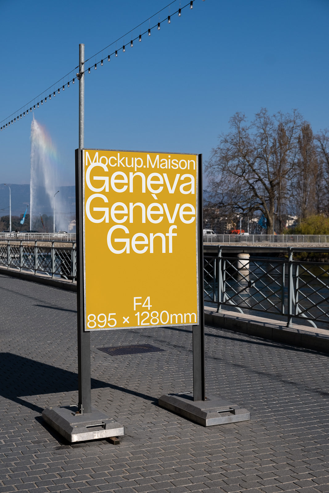 PSD mockup of a standing outdoor poster with yellow background, showcasing text "Geneva" in various languages, set beside a fountain and river.