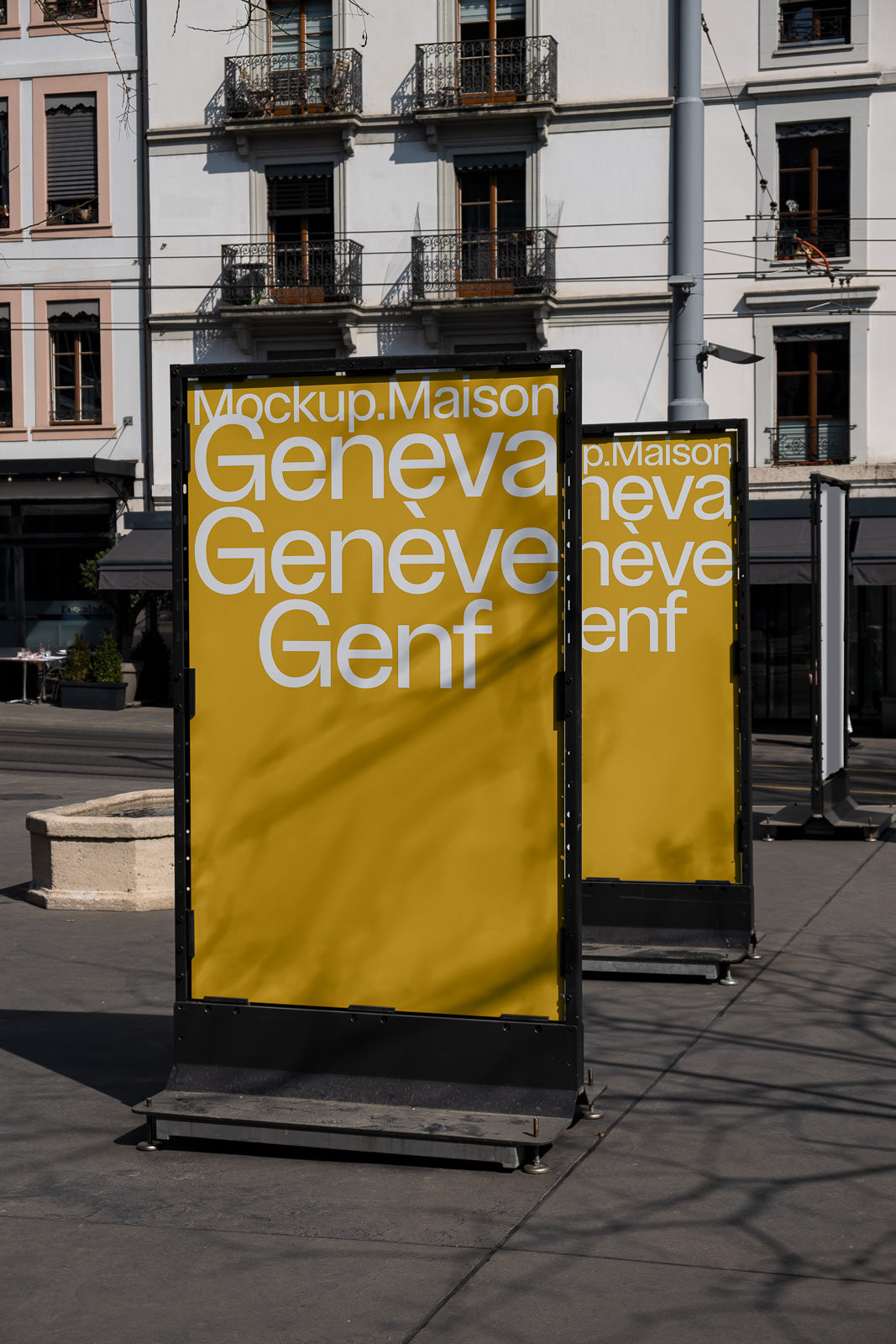 PSD mockup of two outdoor posters with yellow backgrounds displaying the text "Geneva Genève Genf" in front of an urban building facade.