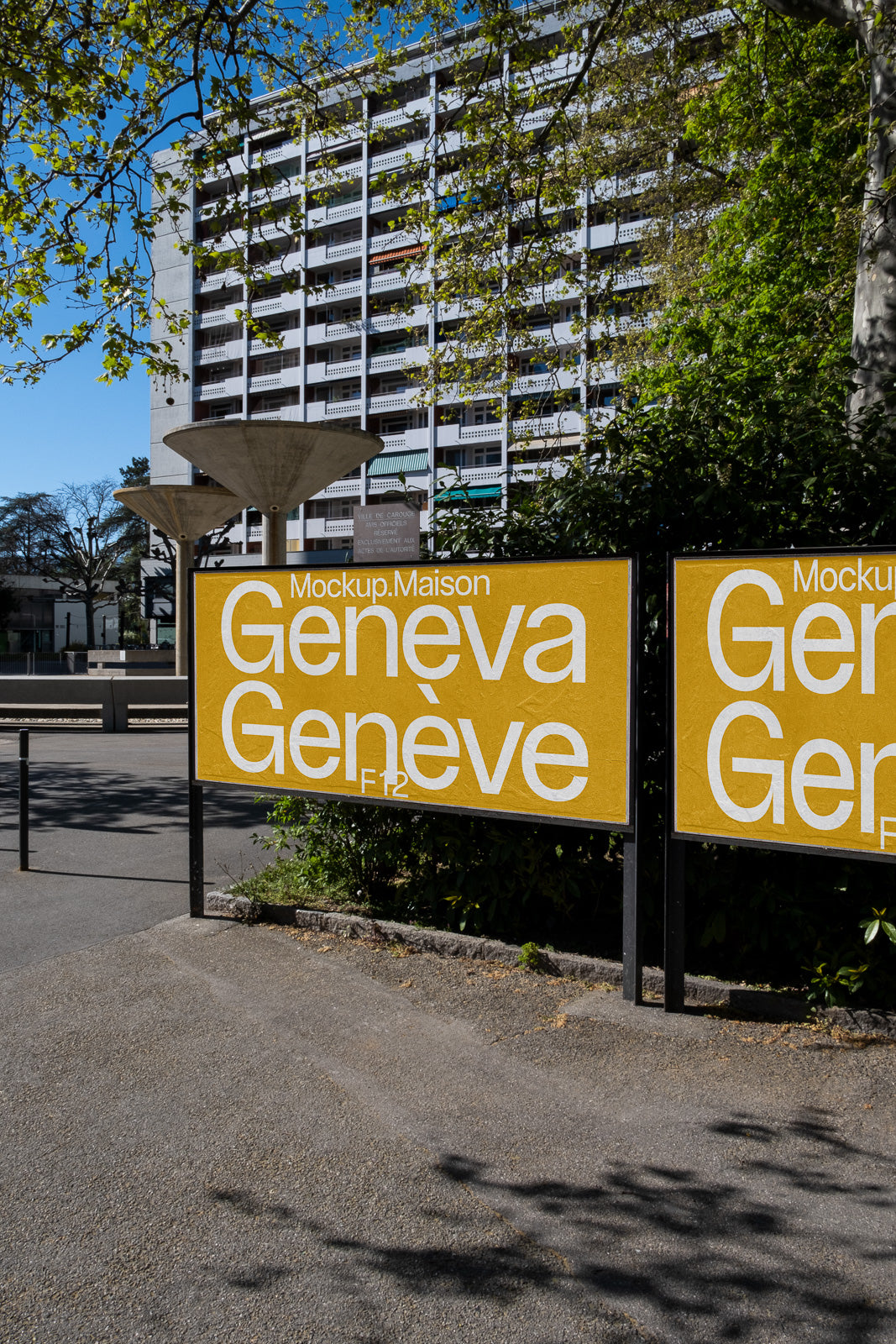 PSD mockup of a building exterior with two large, yellow advertisement posters displaying "Geneva," surrounded by urban scenery and trees.