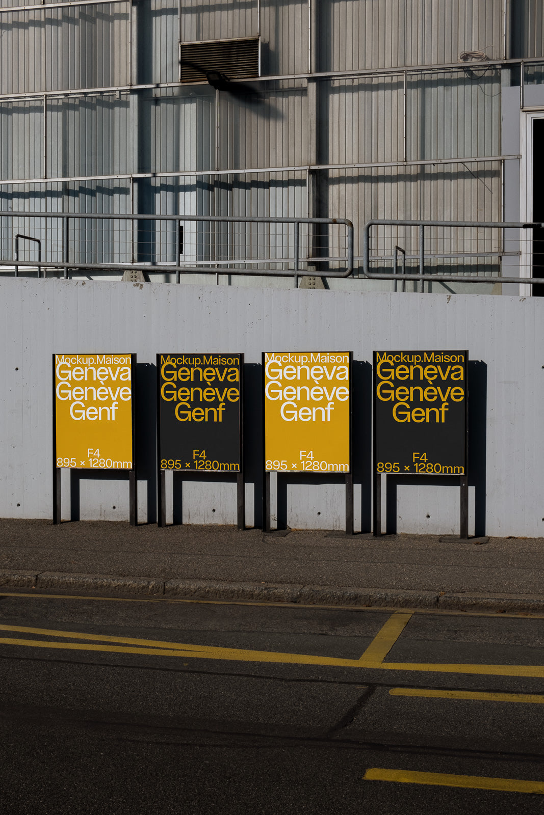 PSD mockup of four standing F4 size posters against an industrial building wall, featuring yellow and black designs with text mentioning Geneva.