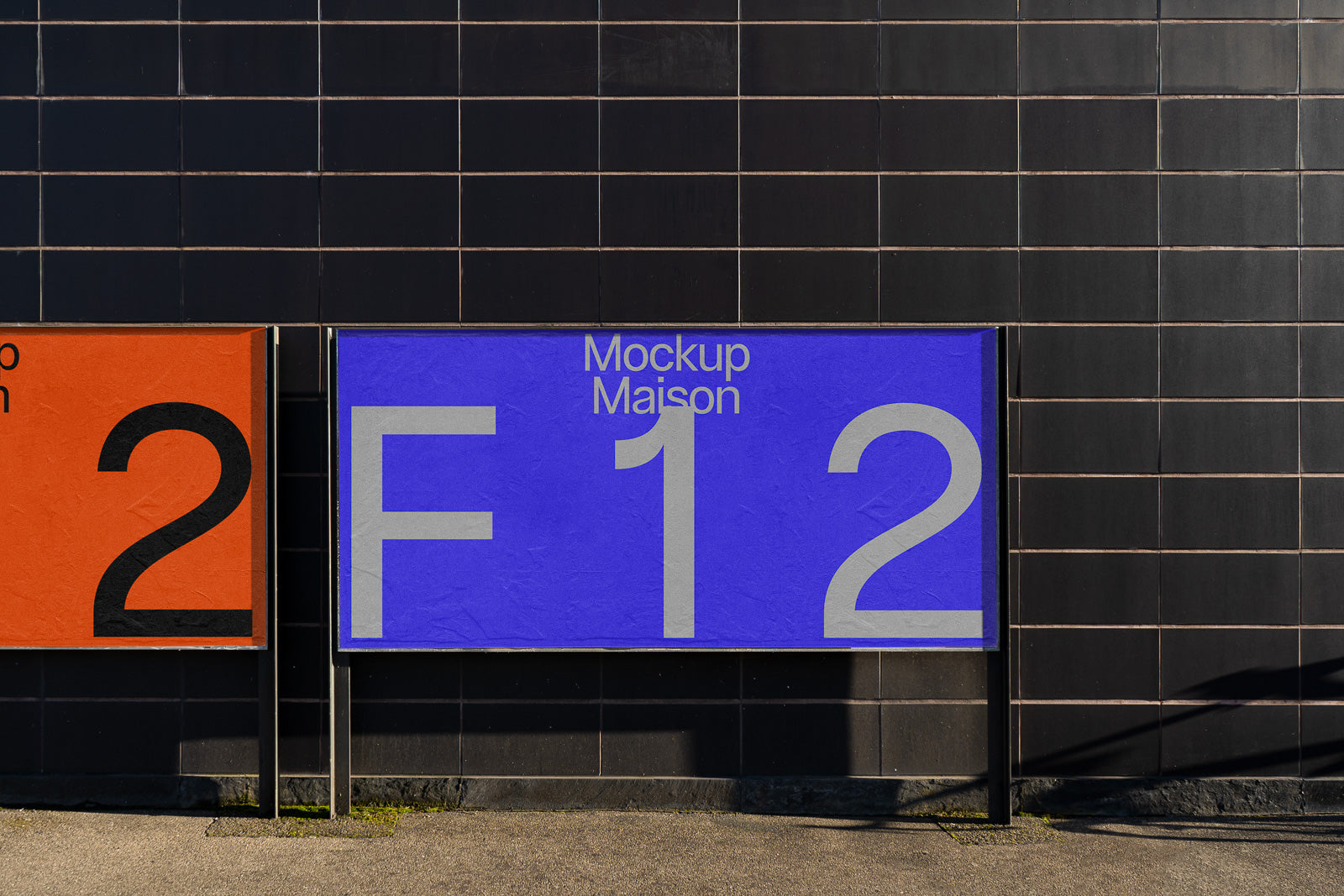 PSD mockup of a large outdoor signage displaying "Mockup Maison F12" against a dark tiled wall, with shadows cast on the ground.