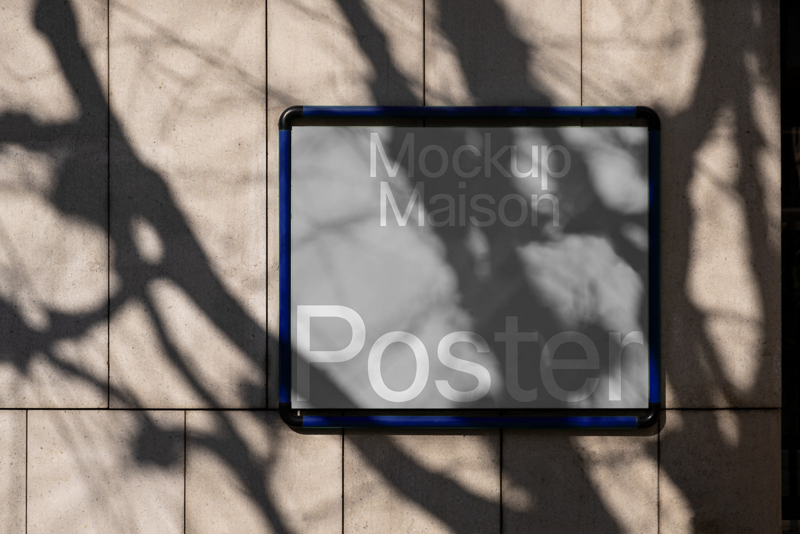 PSD mockup of a framed poster on a textured wall with tree shadows, displaying the text "Mockup Maison Poster" in a minimalist design.