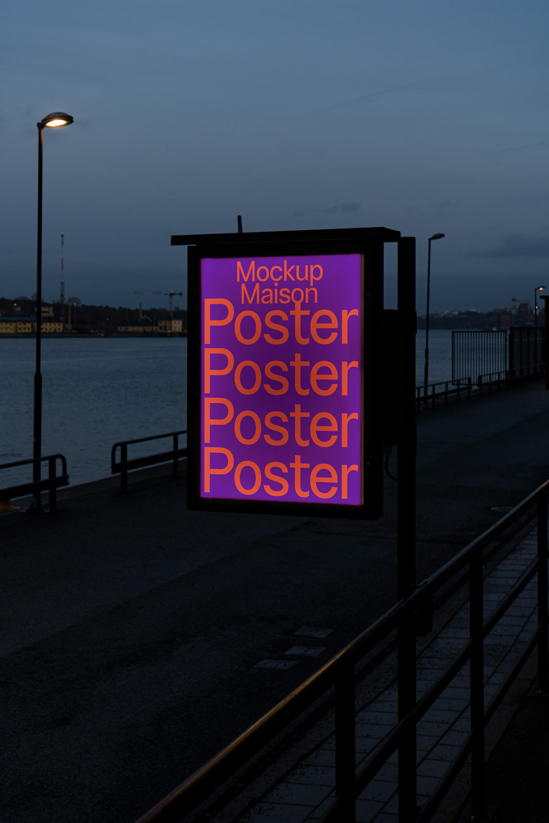 PSD mockup of a poster displayed in outdoor signage by a riverside, featuring bold orange text "Mockup Maison Poster" on a purple background.