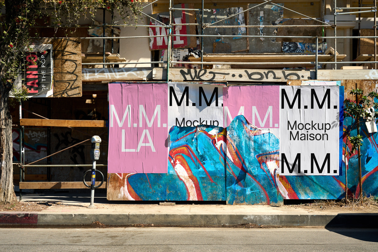 PSD mockup of urban street scene with colorful abstract graffiti art and M.M. posters on a construction barrier, sunlight casting shadows.