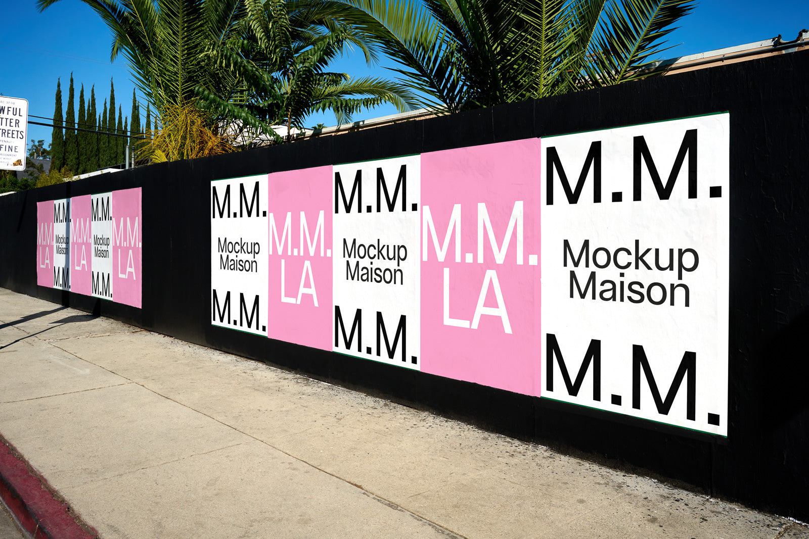PSD mockup of a street scene with a series of posters on a black wall. The posters feature "M.M. Mockup Maison" and "M.M. LA" in bold text on white and pink backgrounds.