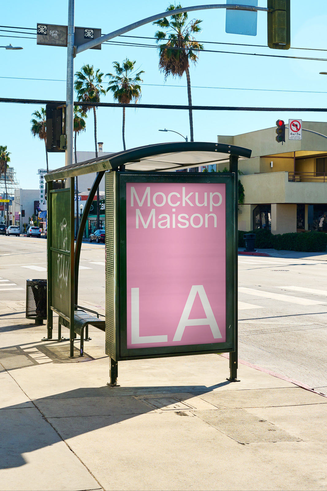 PSD mockup of a bus stop advertisement display on a sunny Los Angeles street, featuring palm trees and buildings in the background.