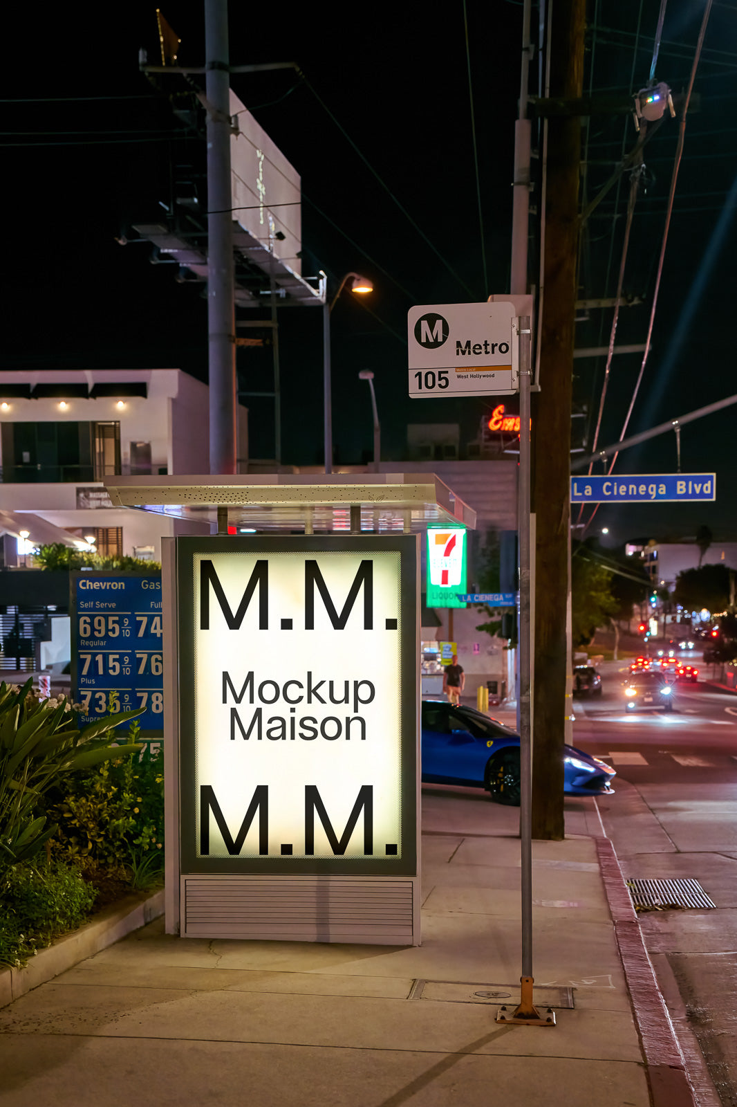 PSD mockup of an illuminated bus stop ad space at night, featuring text "M.M. Mockup Maison M.M." with street signs and blurred city lights in the background.