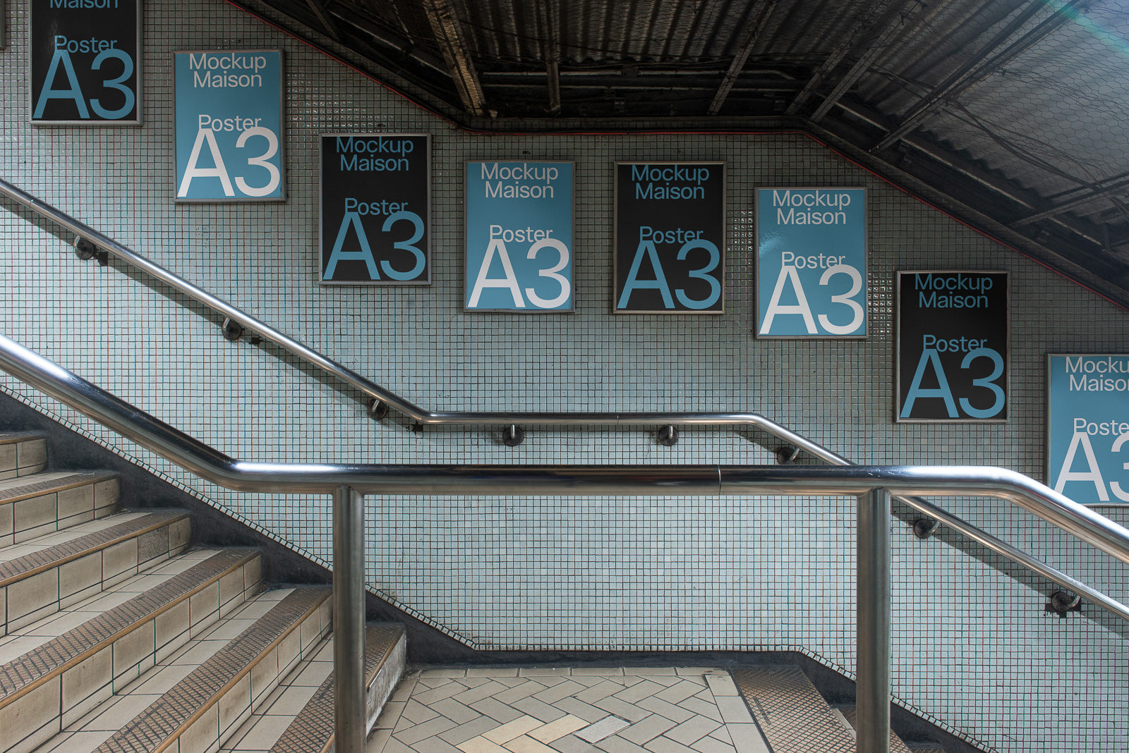 PSD mockup of multiple A3 posters displayed on a tiled wall along a stairway, featuring the text "Mockup Maison Poster A3" in various colors.
