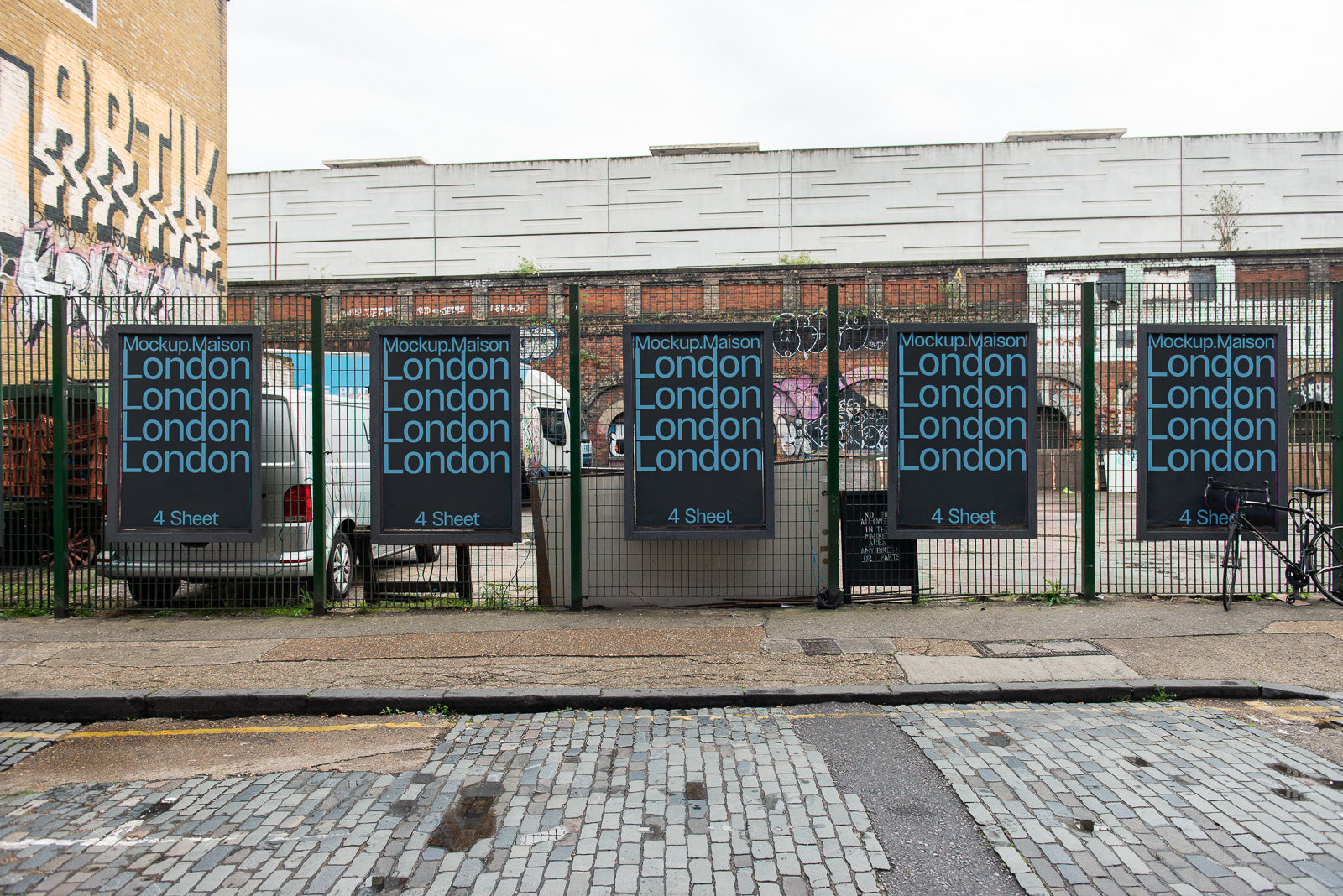 PSD mockup of four urban posters displayed on a fence in London, showcasing a minimalist design with repeated text and street art in the background.