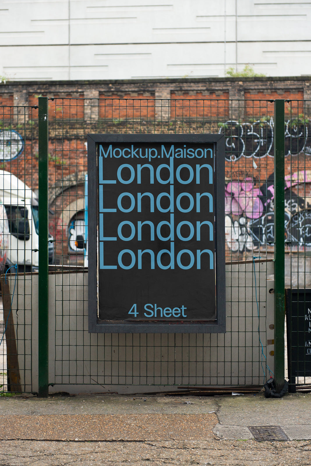 PSD mockup of an outdoor poster on a fence with the word "London" repeated in blue text against a dark background.