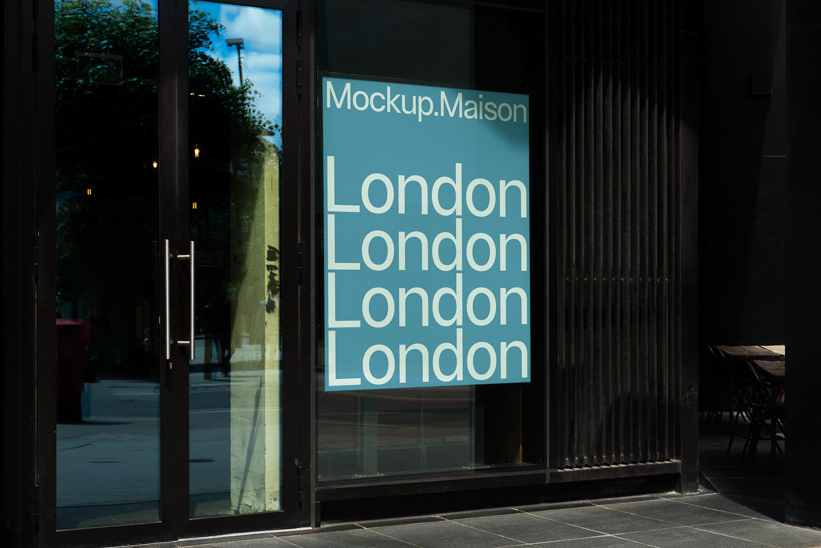 PSD mockup of a blue window sign with the repeated text "London" displayed in white font at an angle outside a modern building.