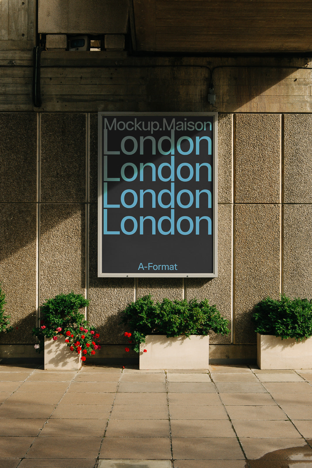 PSD mockup of a wall-mounted poster displaying the word "London" repeatedly in light blue text, surrounded by planters with red flowers.