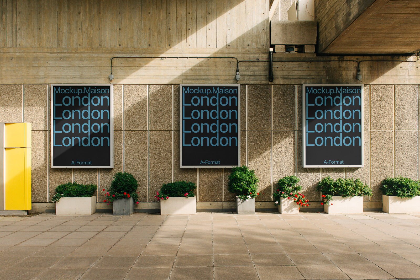 PSD mockup of three large posters on an urban concrete wall, each displaying the word "London" in a distinctive font.