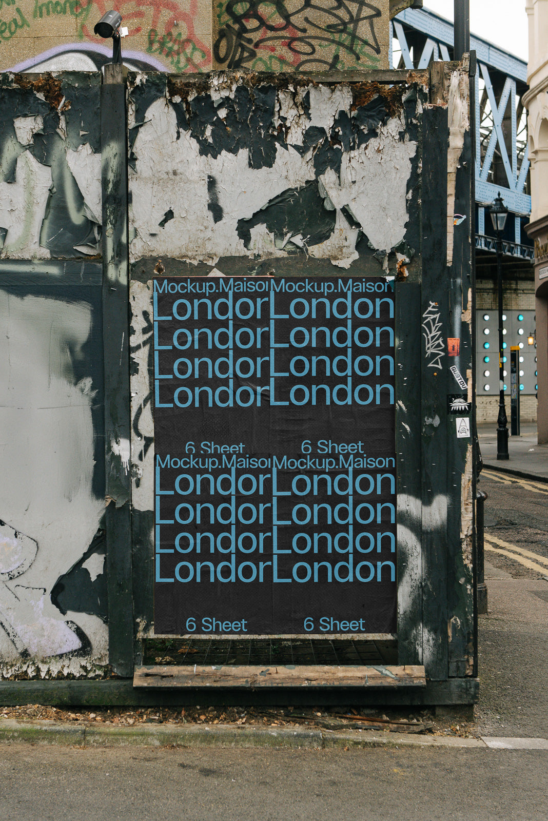 PSD mockup of six sheets on a weathered wall with repetitive text "London" in blue, alongside urban graffiti and a partially visible street.