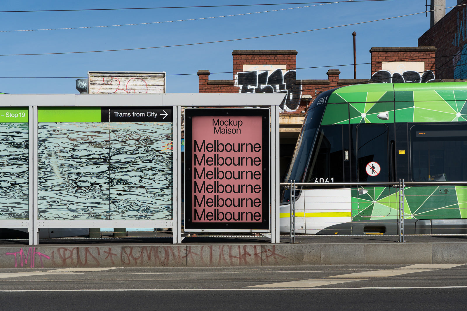 PSD mockup of a tram stop featuring a pink poster with the word "Melbourne" repeated in bold black text beside a green tram.
