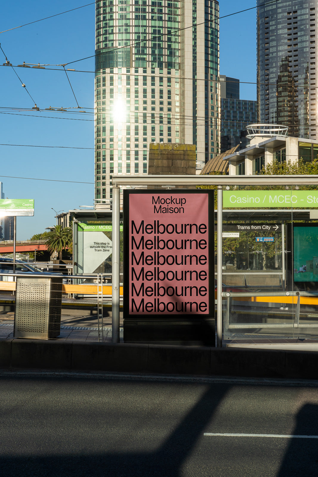 PSD mockup of a street sign displaying "Melbourne" multiple times against an urban skyline with tall buildings and clear sky in the background.