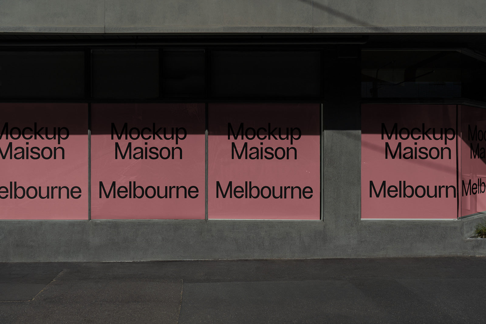PSD mockup of storefront windows with pink backgrounds displaying the text "Mockup Maison Melbourne" in black font.