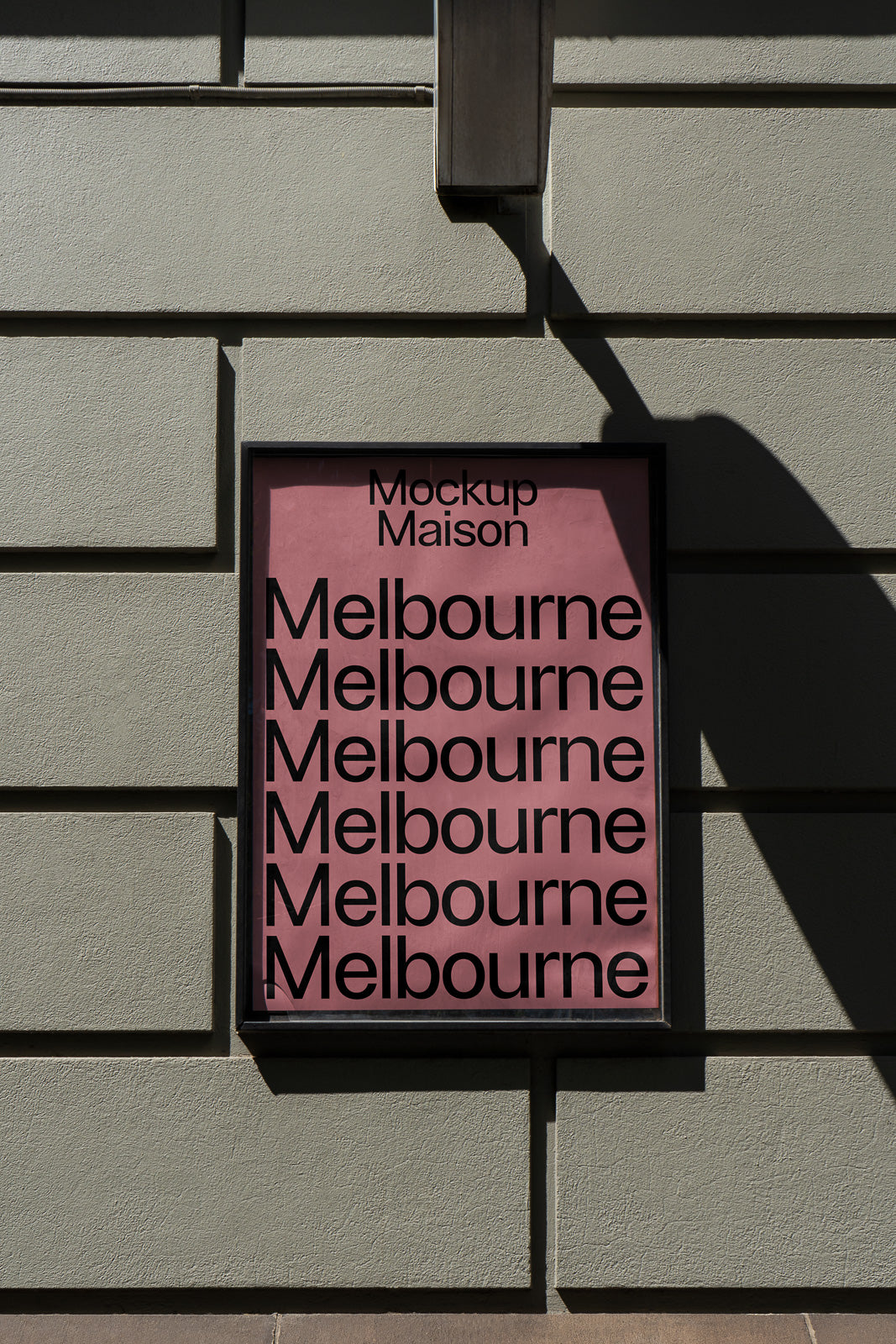 PSD mockup of an urban poster on a wall, featuring repeated text "Melbourne" in bold black letters against a pink background with shadows.