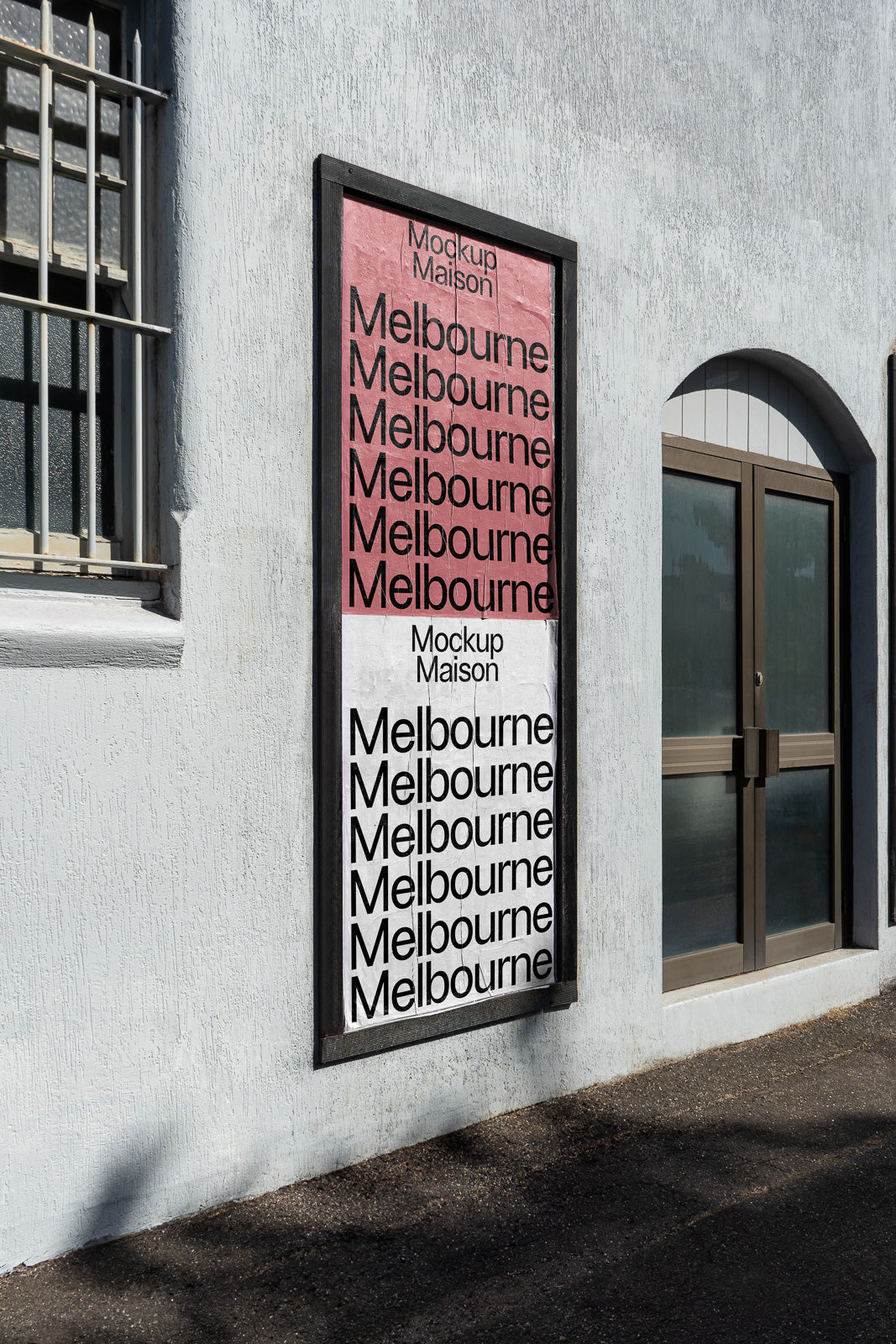 PSD mockup of a framed outdoor poster with repeated "Melbourne" text on pink and white sections, displayed on a textured wall next to a door.