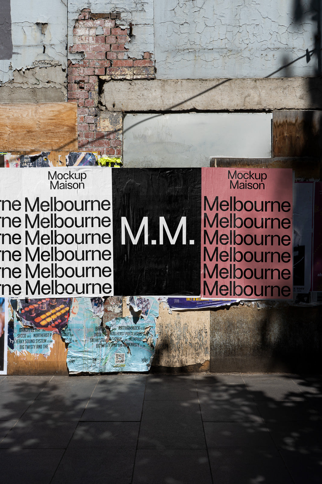 PSD mockup of posters on a weathered urban wall, featuring bold text "Melbourne" and "M.M." on varying backgrounds, with torn paper accents.