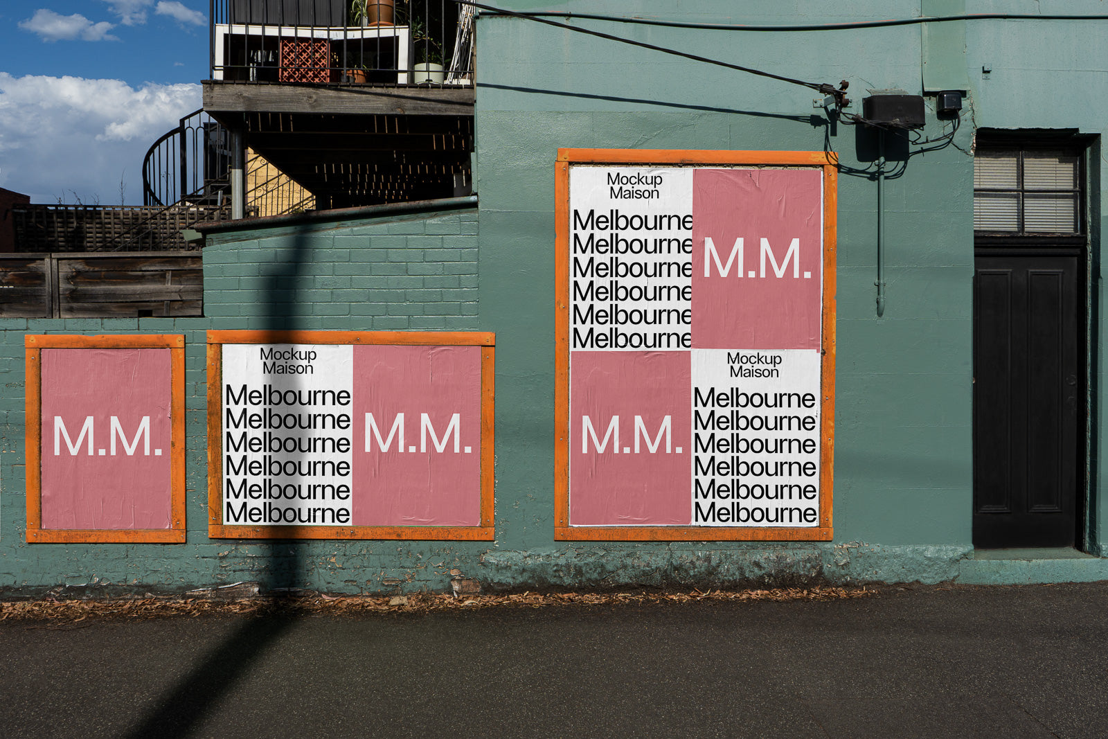 PSD mockup of posters on a green wall, featuring "M.M." in pink squares and repeated "Melbourne" text in black on white backgrounds with orange frames.