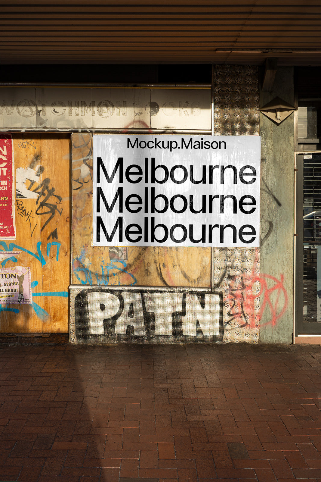 PSD mockup of a poster against a weathered wall covered in graffiti and signage with the word "Melbourne" repeated in bold letters.