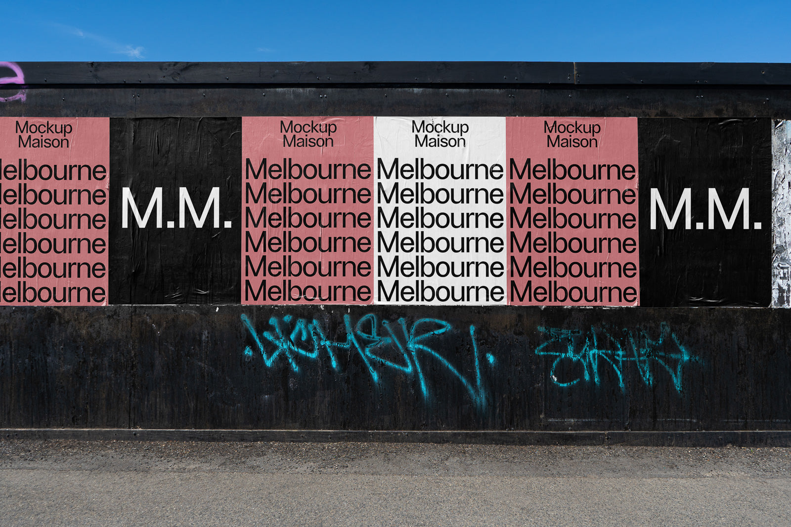 PSD mockup of urban wall showing posters with text "Melbourne" and "M.M." against a background with graffiti.