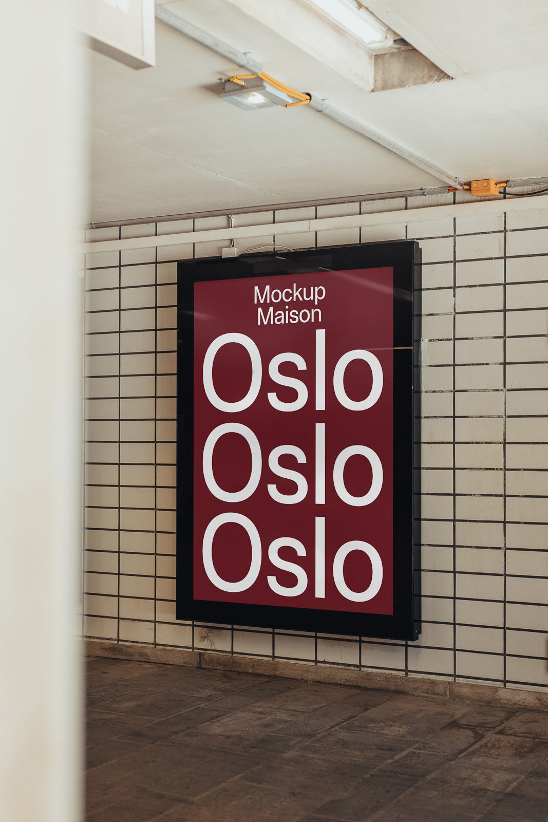 PSD mockup of a large poster in a tiled subway setting, displaying the text "Mockup Maison Oslo" on a dark red background.
