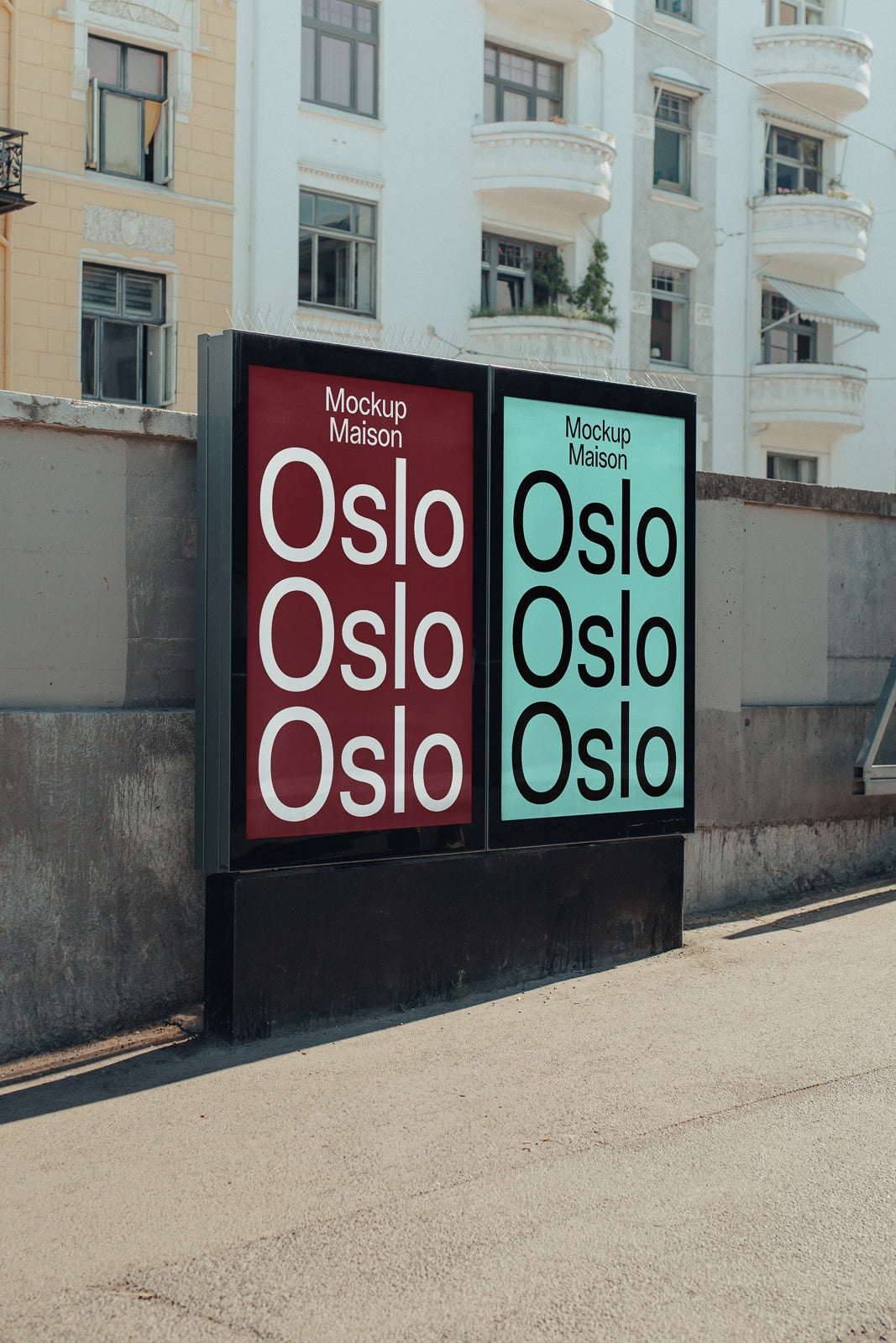 PSD mockup of two outdoor advertising posters displayed side by side on a street, featuring the text "Oslo" in bold letters against red and blue backgrounds.