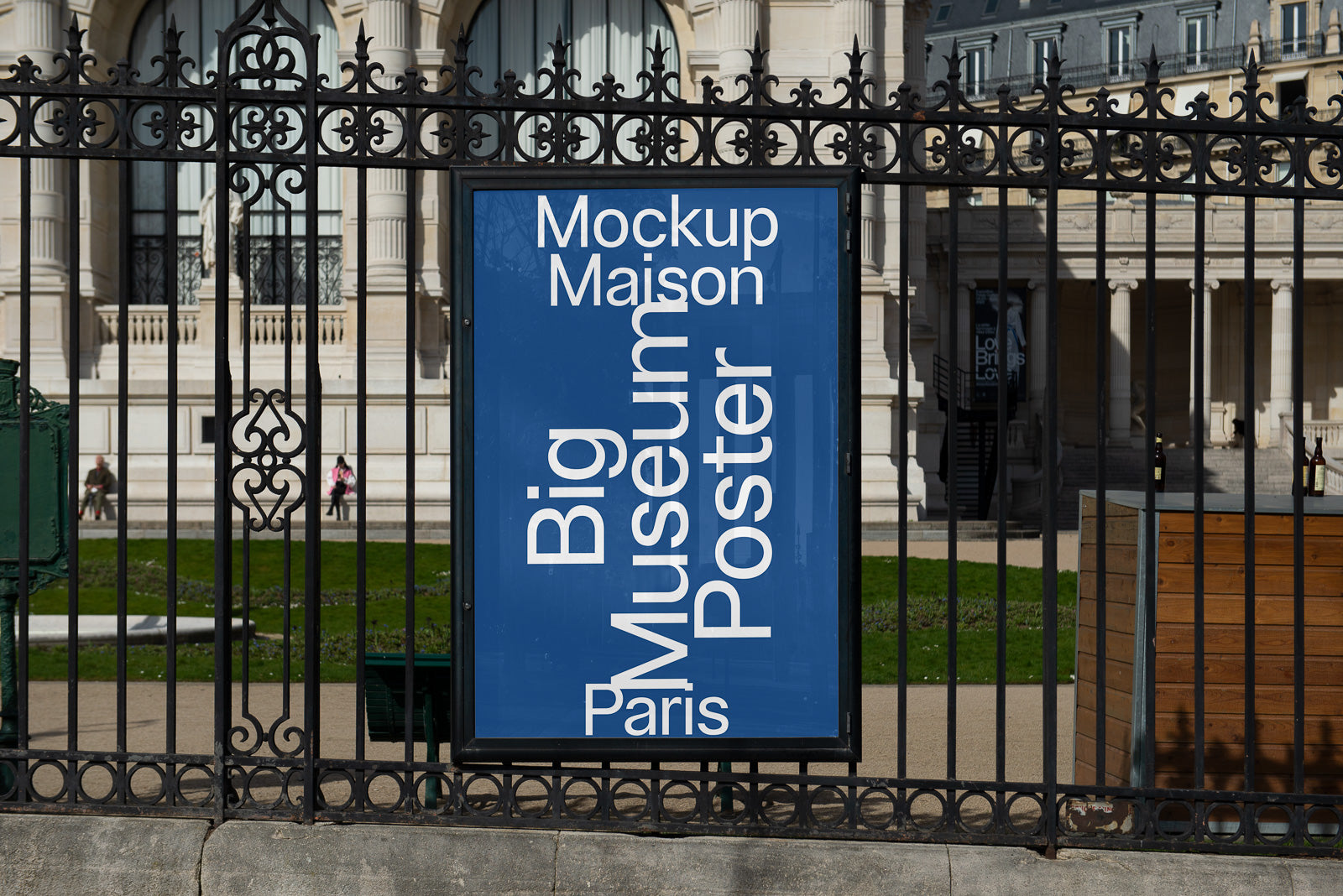 PSD mockup of a vertical blue poster on a wrought iron fence with text "Mockup Maison Big Museum Poster Paris" in a classic building setting.