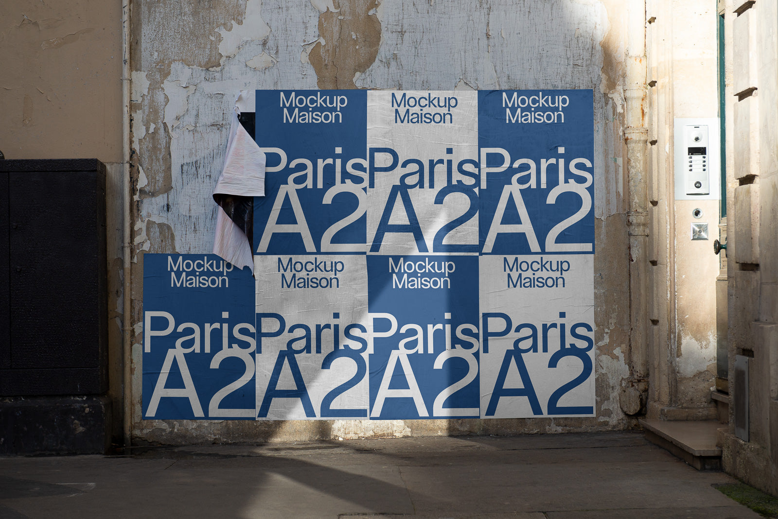 PSD mockup of blue and white posters on a textured wall, displaying "Paris A2" and "Mockup Maison" text, partially peeling at the corner.