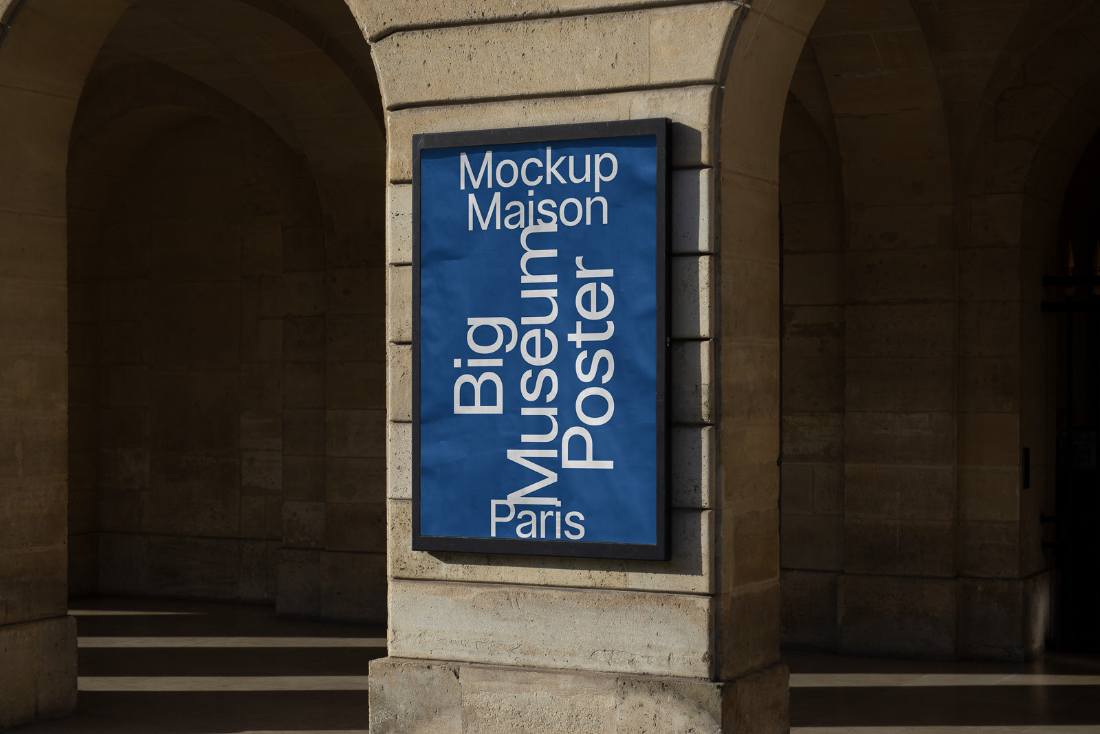 PSD mockup of a large blue poster displayed on a stone building archway, reading "Mockup Maison Big Museum Poster Paris" in white text.