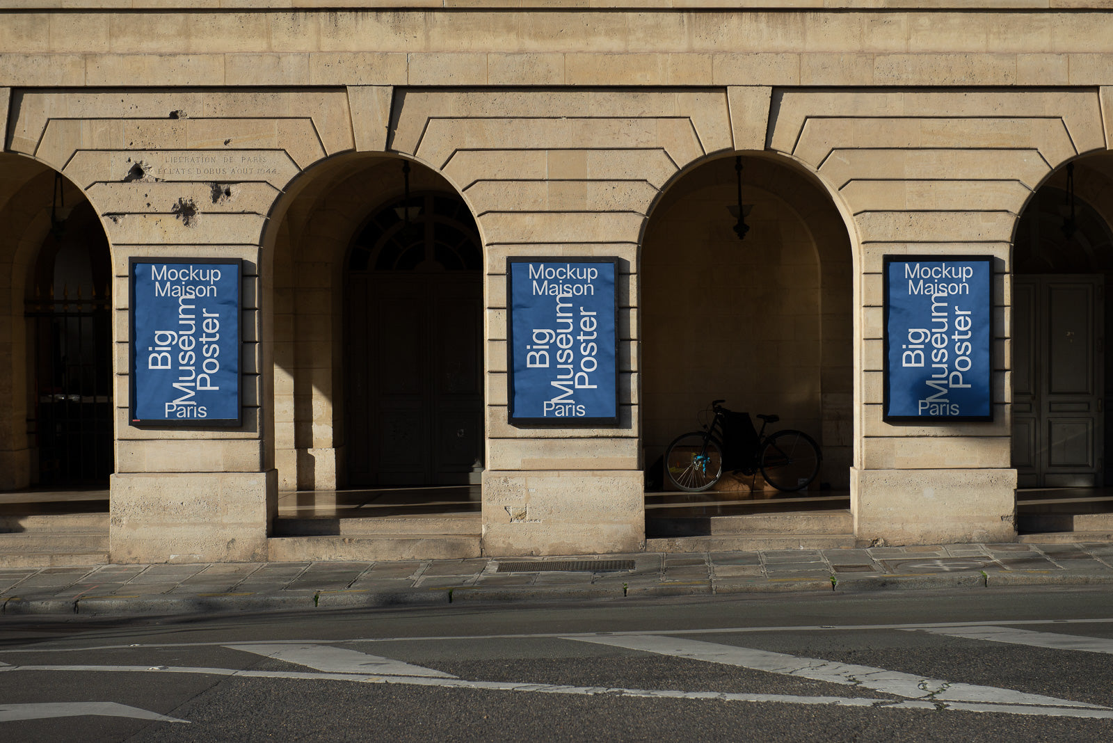 PSD mockup of three large museum posters displayed on an arched stone wall, with shadows and a bicycle partially visible in the background.