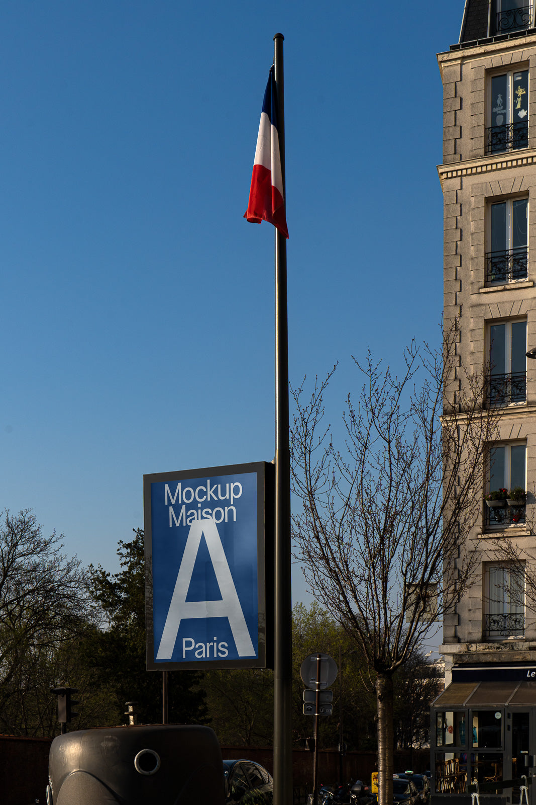 PSD mockup of a street sign with "Mockup Maison A Paris" beside a building and French flag against a clear blue sky.