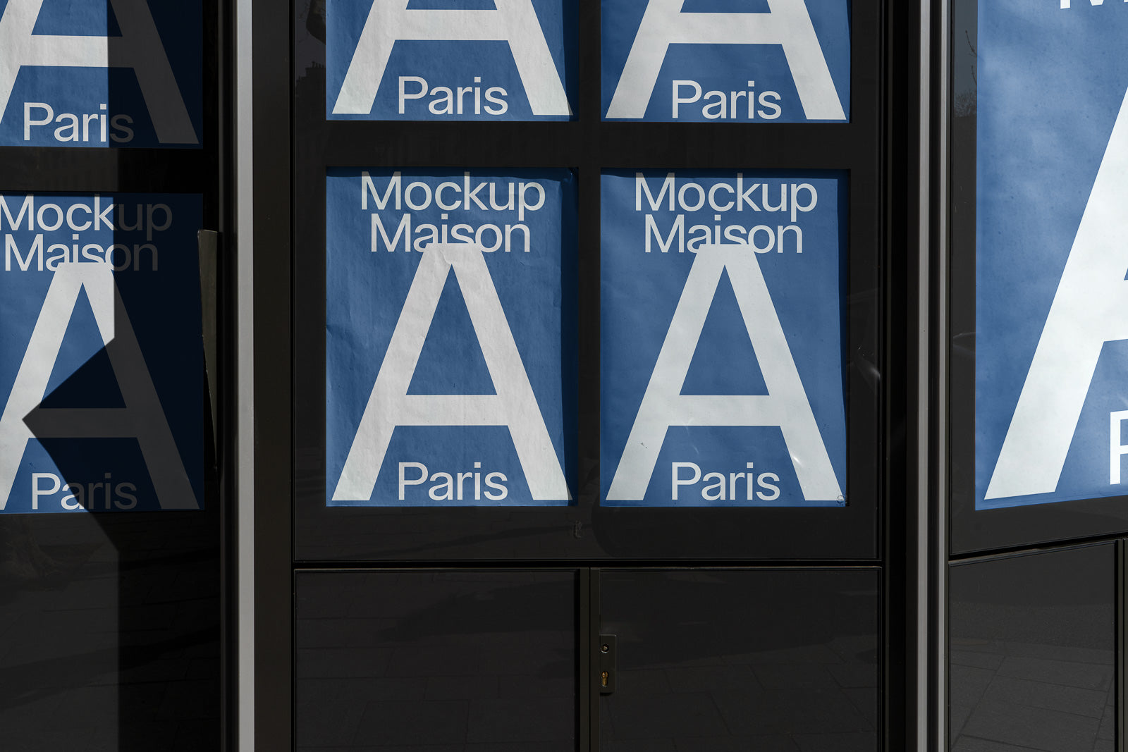 PSD mockup of large blue posters with "A" and "Paris" text displayed on a storefront window, casting shadows in natural light.