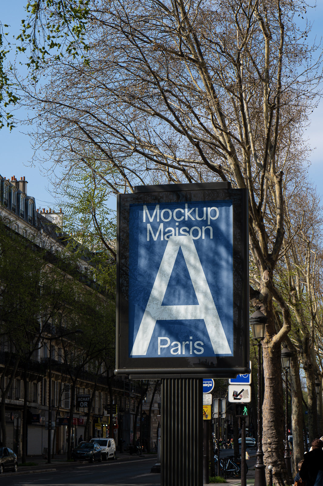 PSD mockup of a street billboard displaying "Mockup Maison A Paris" against a backdrop of leafless trees and urban street scenery.