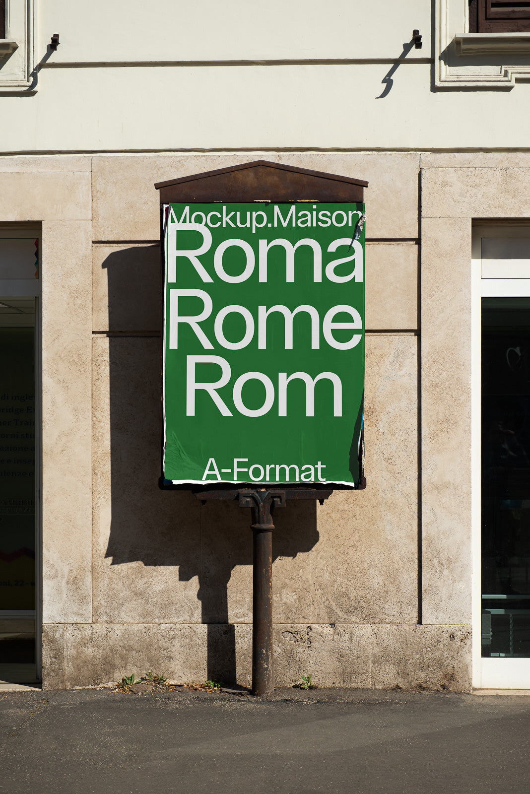PSD mockup of a green vertical poster on a beige stone wall, displaying text variations of "Roma" in multiple languages with large white letters.