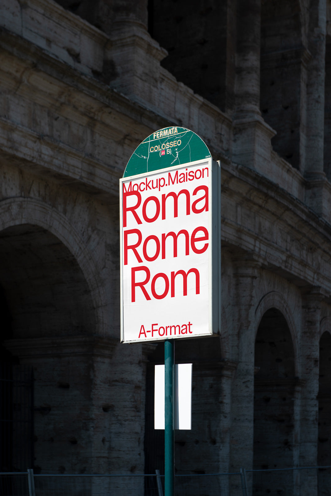 PSD mockup sign in front of architectural structure, displaying "Mockup.Maison Roma Rome Rom" in large red text on a rectangular board.